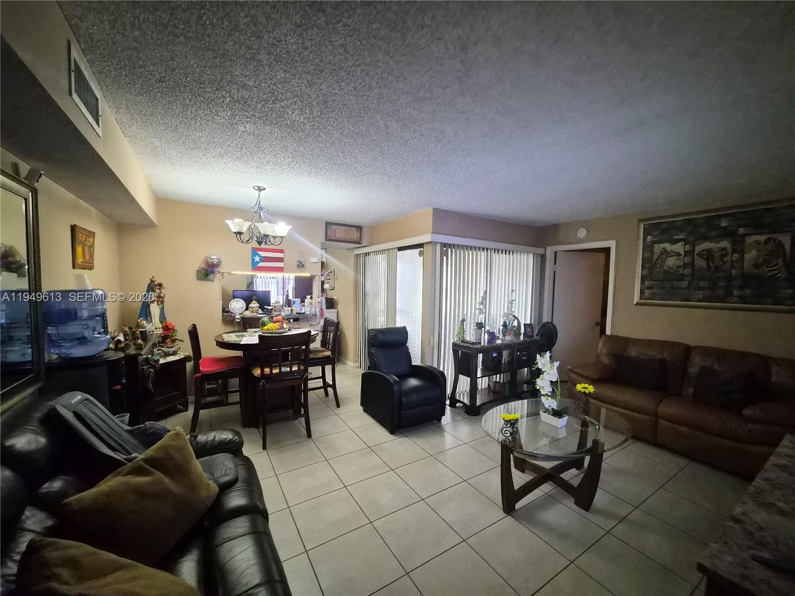 800 Independence Drive, Unit 800F Homestead, FL 33034 - Photo 8 of 26 a living room with furniture and a large window