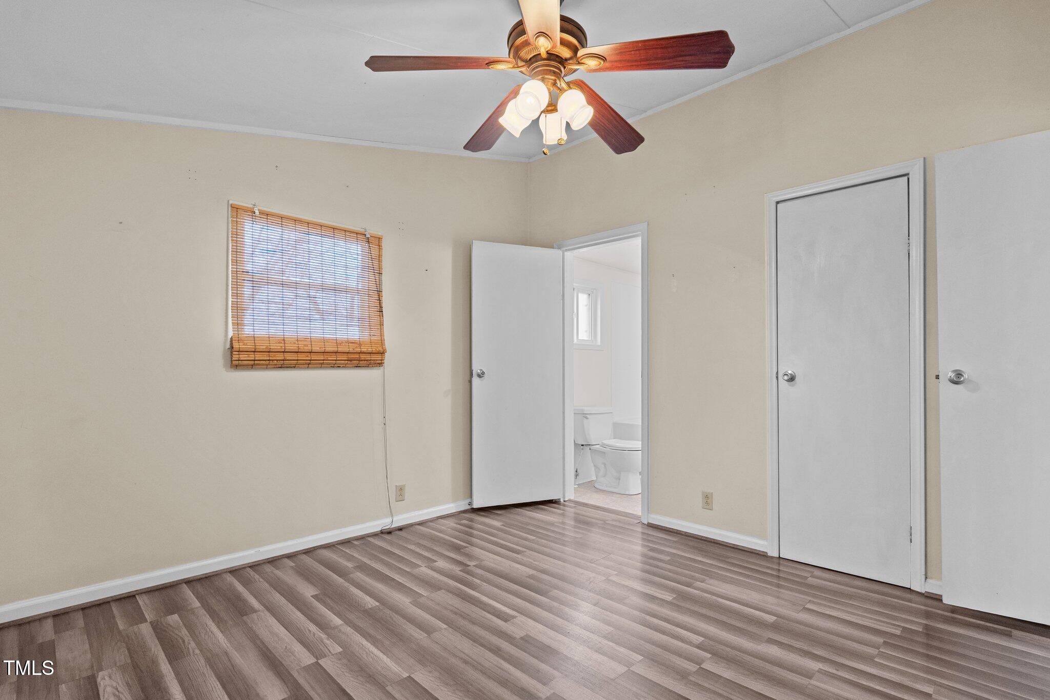 578 Marler Road Benson, NC 27504 - Photo 41 of 55 an empty room with wooden floor closet and fan