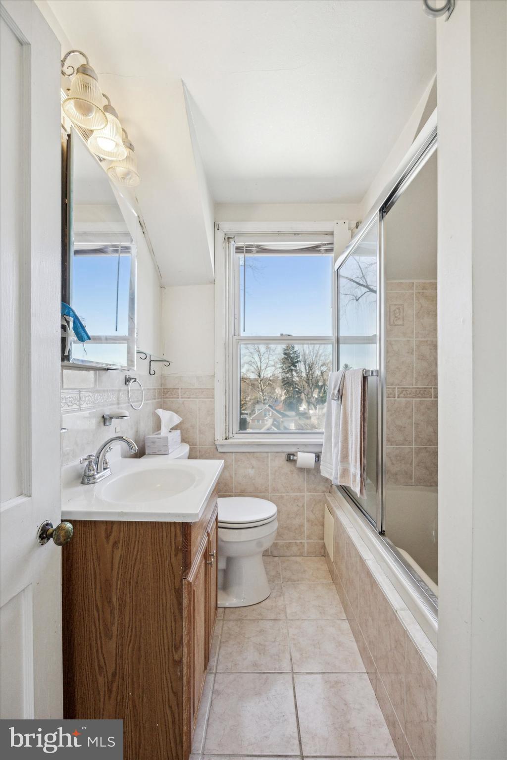 2044 Jenkintown Road Glenside, PA 19038 - Photo 17 of 33 a bathroom with a granite countertop sink toilet and shower