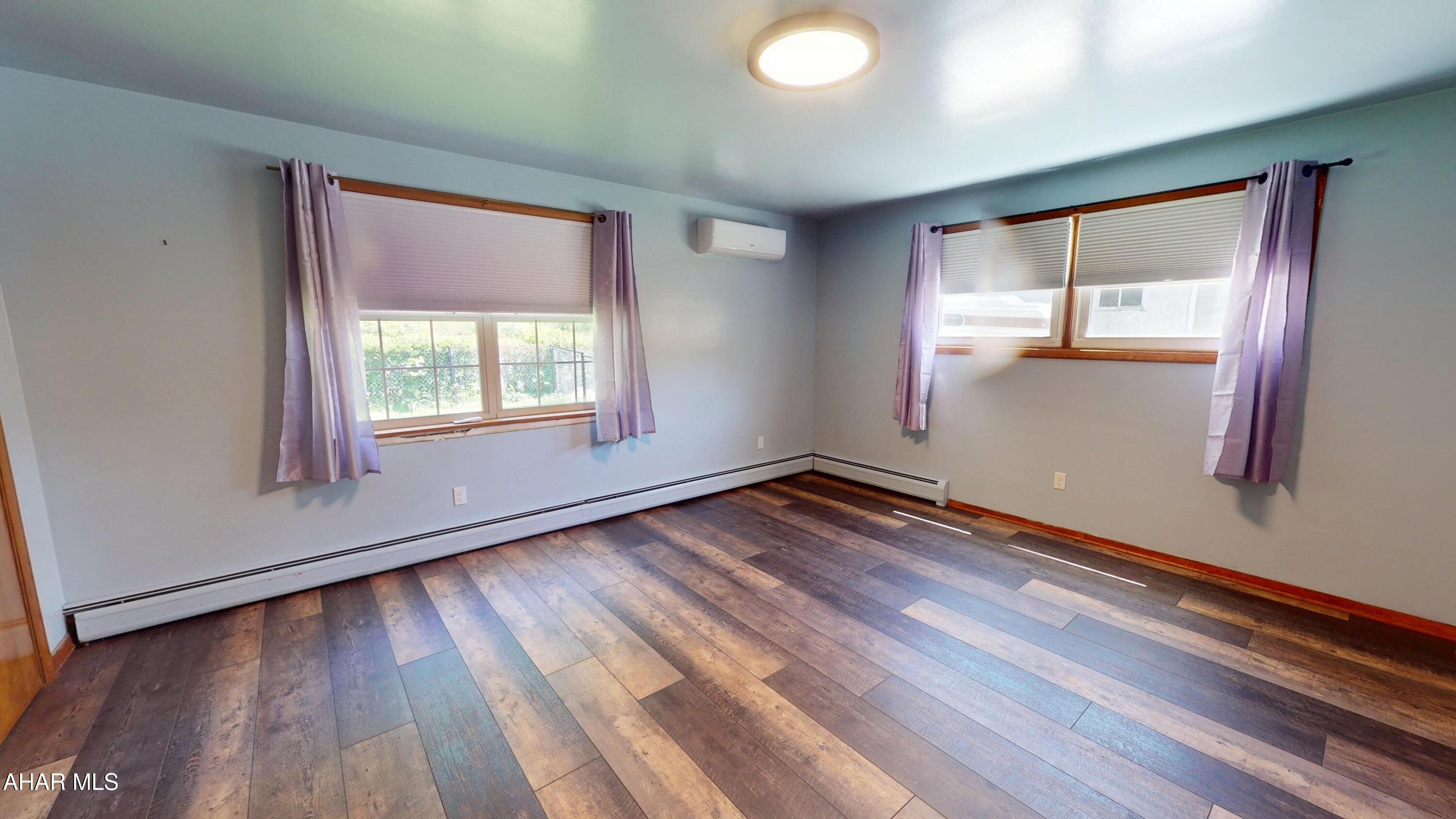 871 Decker Hollow Road Tyrone, PA 16686 - Photo 20 of 35 an empty room with wooden floor and windows