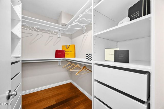 a spacious bathroom with a granite countertop sink a toilet a mirror and shower