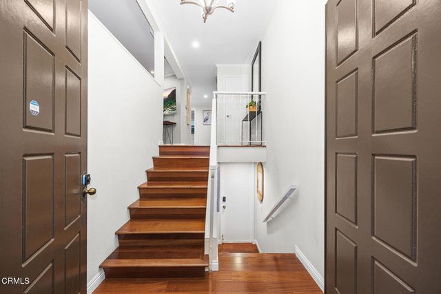 a living room with patio furniture and a large window