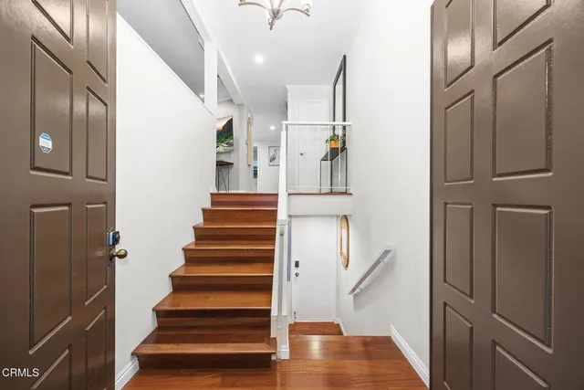 a living room with patio furniture and a large window