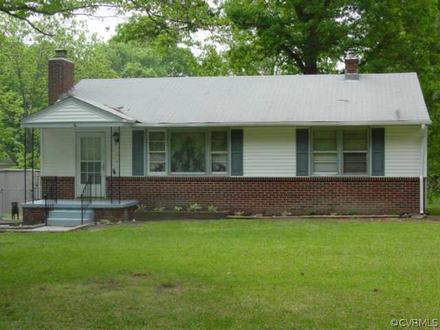 4205 Baldwin Road Chester, VA 23831 - Photo 1 of 1 a backyard of a house with table and chairs