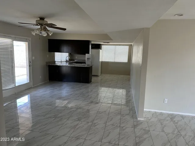 a kitchen with granite countertop a refrigerator and a stove top oven