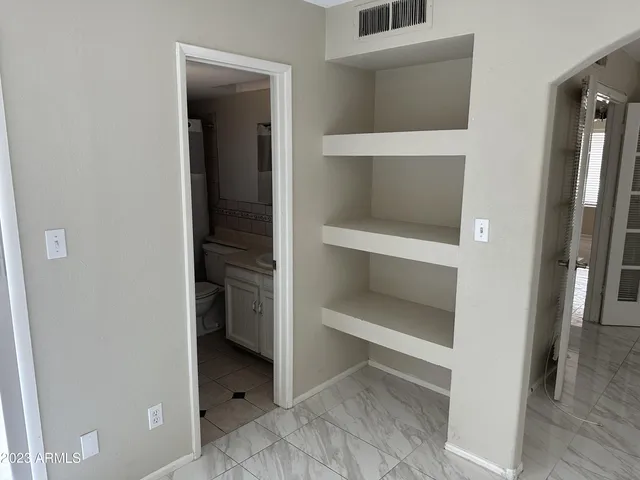 an empty room with windows and entrance