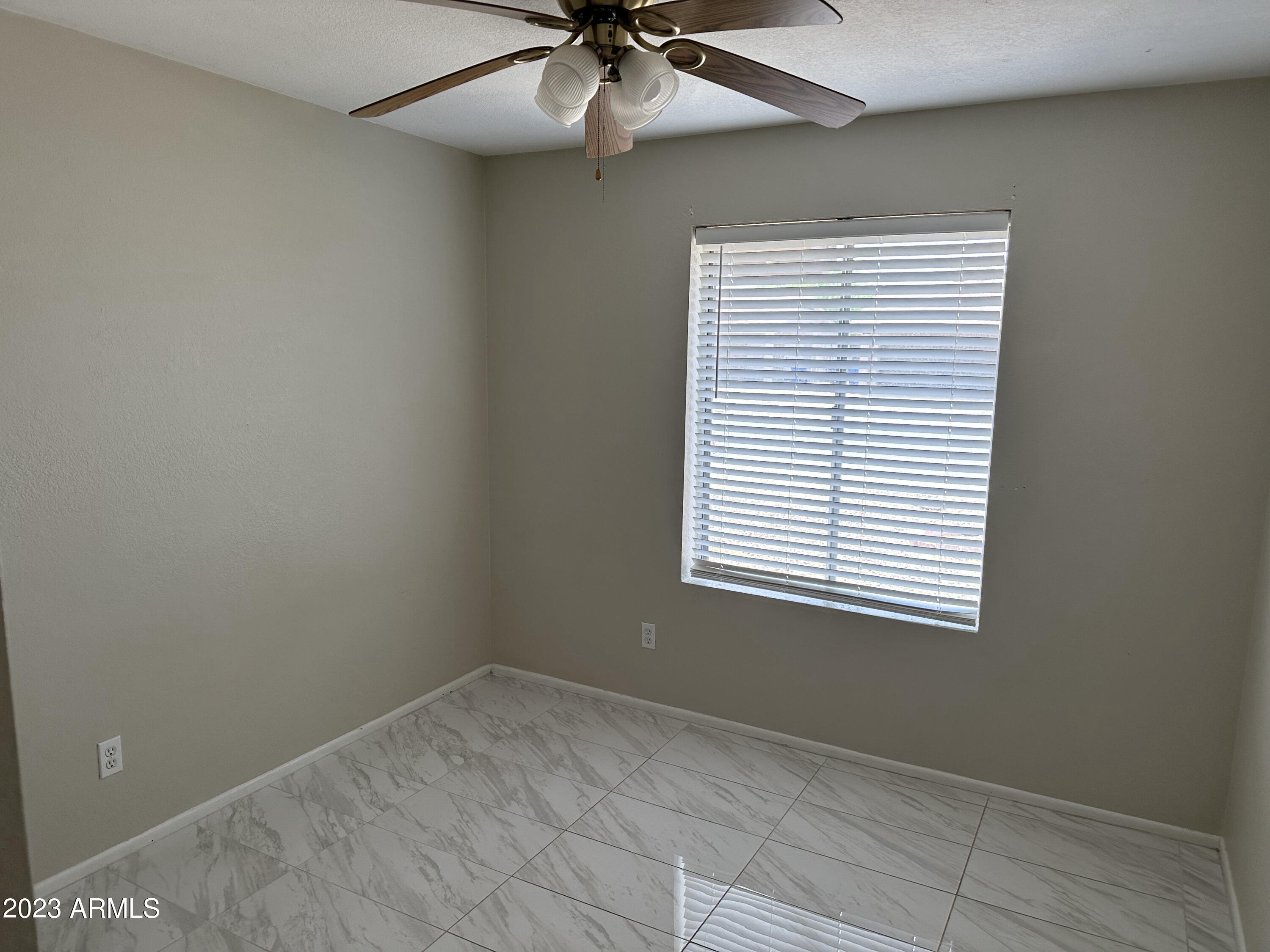 2536 East Commonwealth Circle Chandler, AZ 85225 - Photo 25 of 34 an empty room with a window and a fan