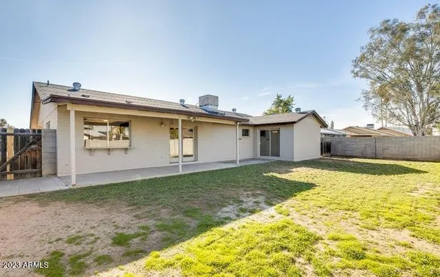 a view of a house with pool and a yard
