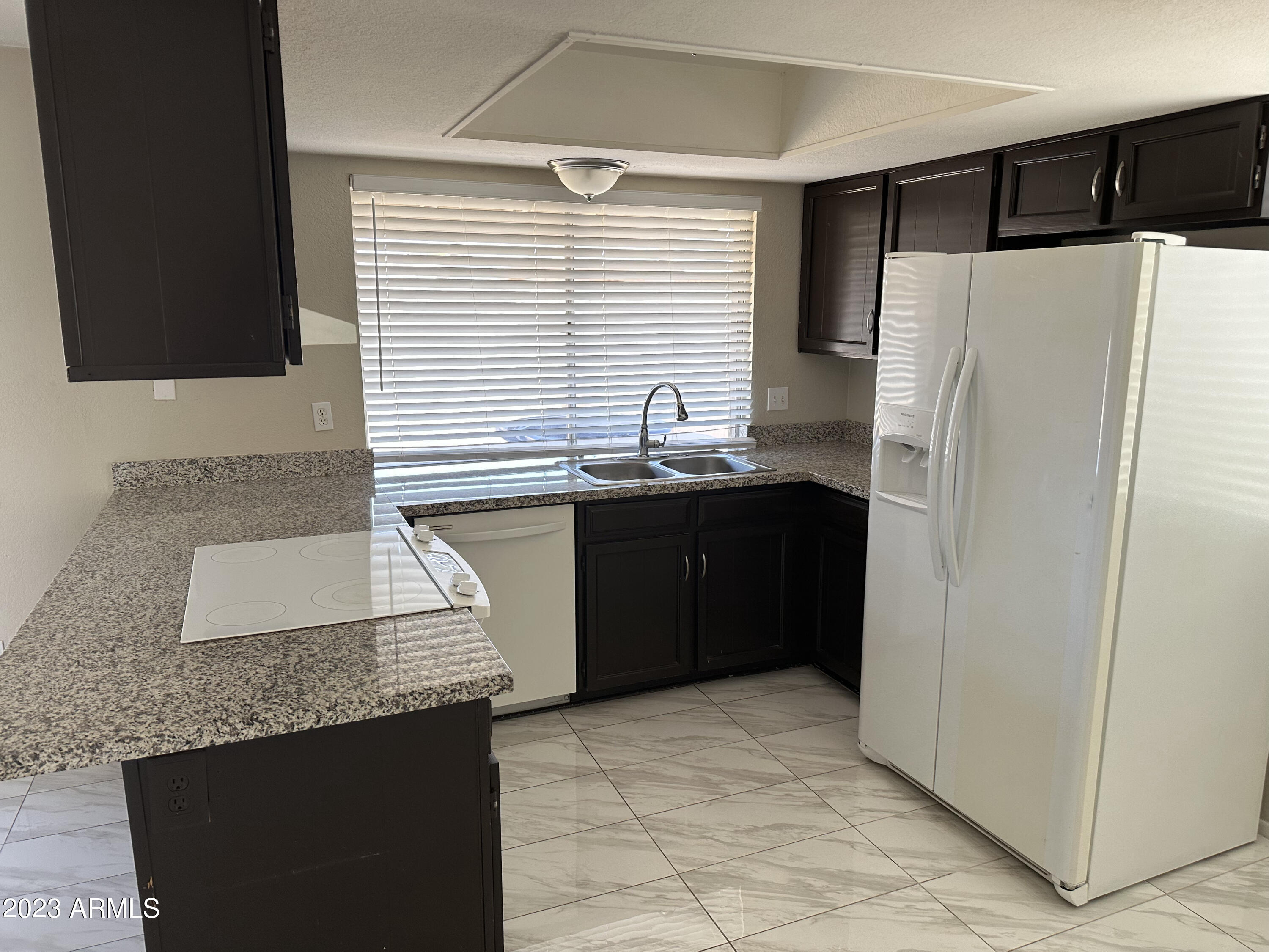 2536 East Commonwealth Circle Chandler, AZ 85225 - Photo 31 of 34 a kitchen with a sink refrigerator and microwave