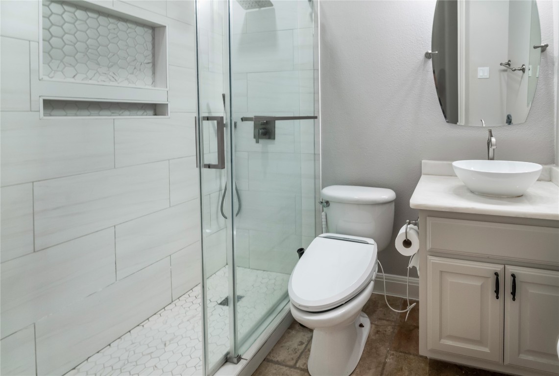 13301 Country Trails Lane Austin, TX 78732 - Photo 19 of 40 Main floor guest bathroom updated with walk-in shower, quartz countertop, newly painted cabinetry, and 2 recessed mirror medicine cabinets for storage.