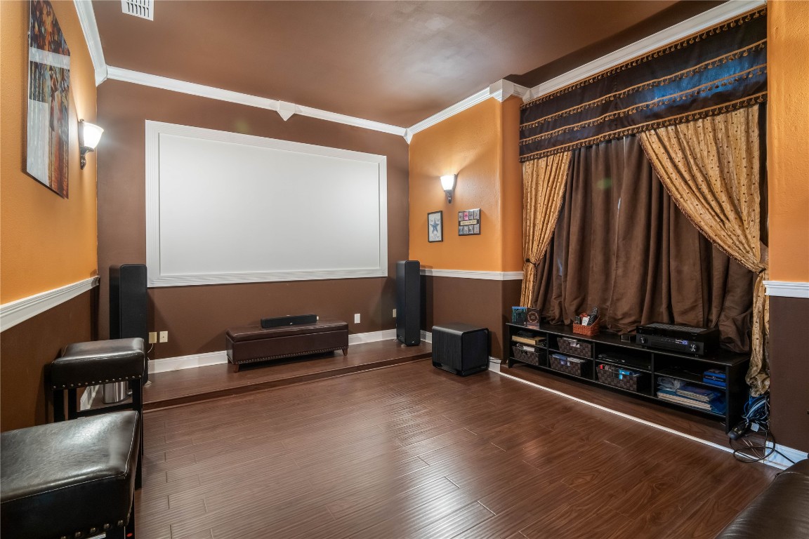 13301 Country Trails Lane Austin, TX 78732 - Photo 20 of 40 Main floor Home theater room featuring wood finished floors and ornamental molding