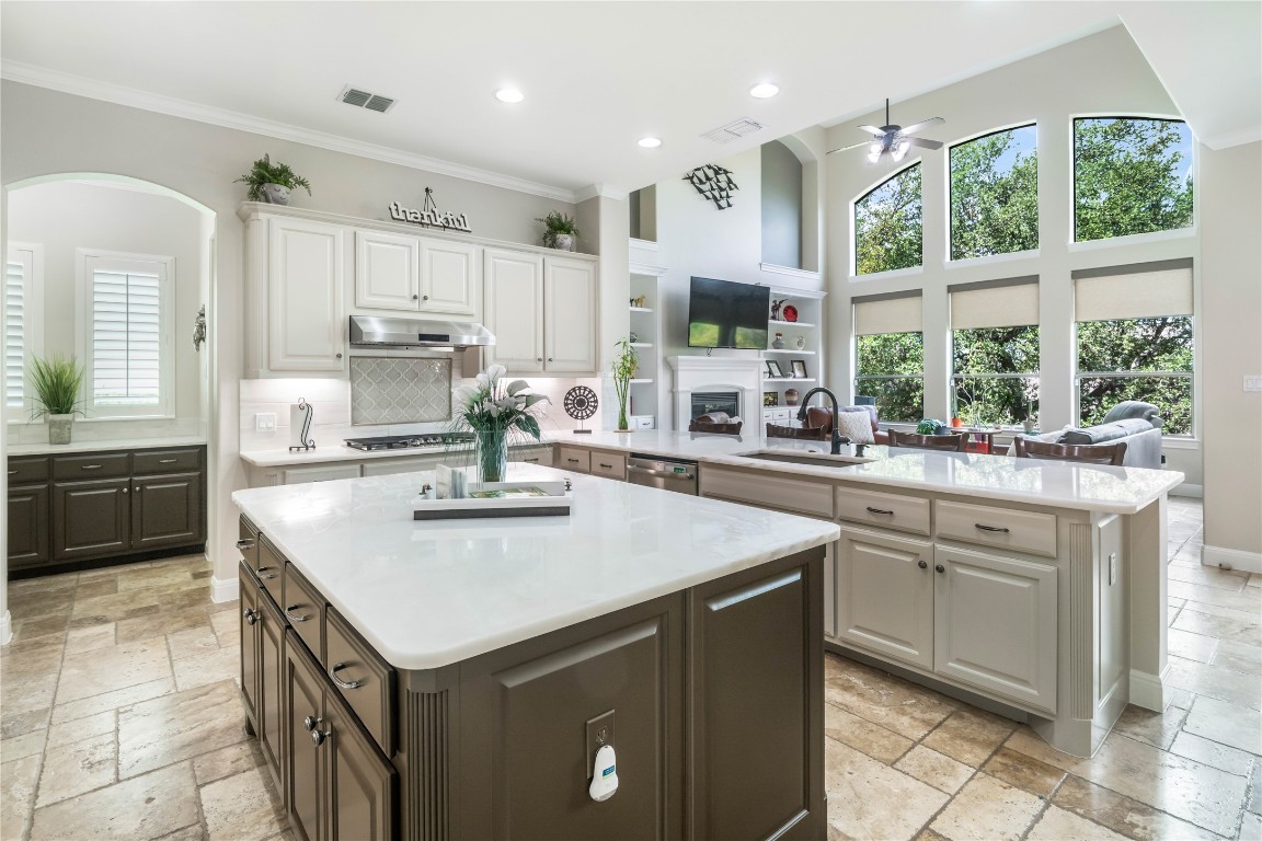 13301 Country Trails Lane Austin, TX 78732 - Photo 2 of 40 Dream Kitchen featuring warm neutral quartzite countertop, oversized island, newly painted cabinetry, and massive storage space