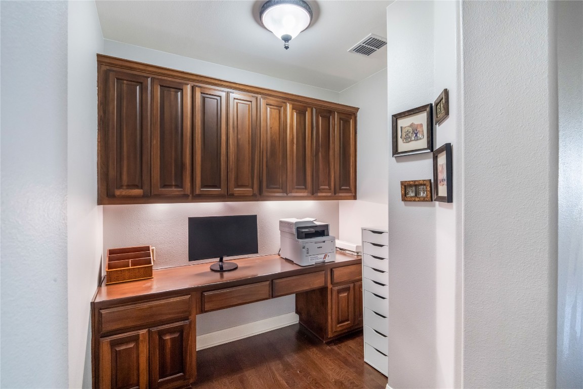 13301 Country Trails Lane Austin, TX 78732 - Photo 29 of 40 Second floor Office area with built in desk and dark wood-style flooring