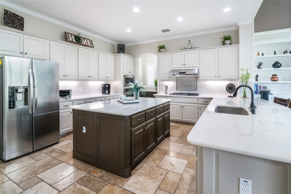 13301 Country Trails Lane Austin, TX 78732 - Photo 4 of 40 Dream Kitchen featuring warm neutral quartzite countertop, oversized island, newly painted cabinetry, and massive storage space