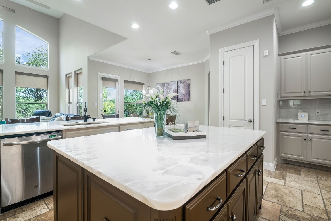 13301 Country Trails Lane Austin, TX 78732 - Photo 8 of 40 Large Kitchen featuring warm tone quartzite countertop, newly painted cabinetry, and stainless steel appliances