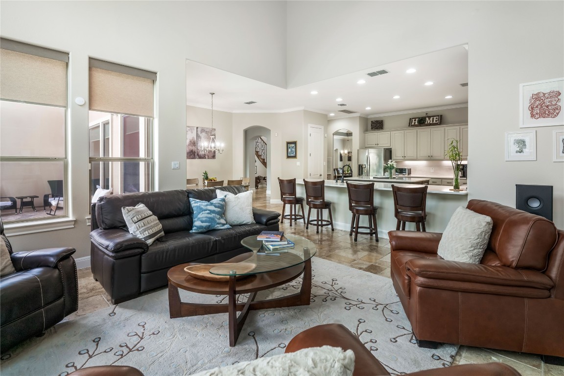 13301 Country Trails Lane Austin, TX 78732 - Photo 9 of 40 Family room with ornamental molding, arched walkways, recessed lighting, a chandelier, and a high ceiling