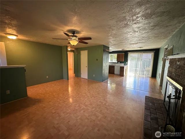 a view of a kitchen with a sink and a refrigerator