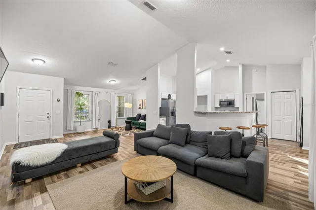 a kitchen with stainless steel appliances granite countertop a sink refrigerator and cabinets