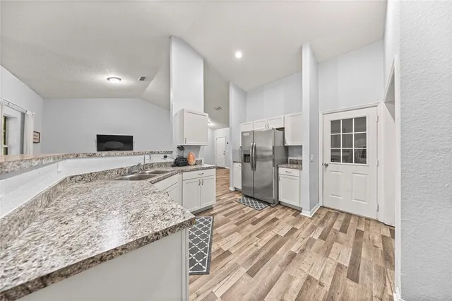 a kitchen with a stove top oven sink and cabinets