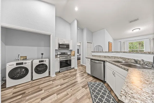 a living room with furniture a window and a potted plant