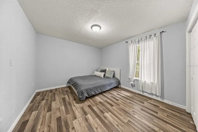 a view of a bedroom with a bed and a window