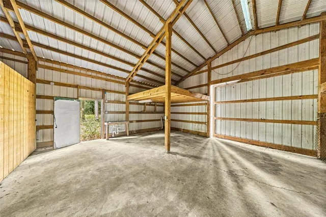 an aerial view of a house with a yard and tree s