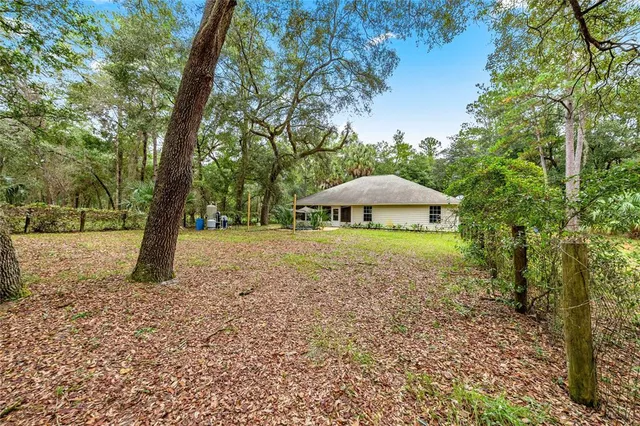 a view of a house with yard and sitting area
