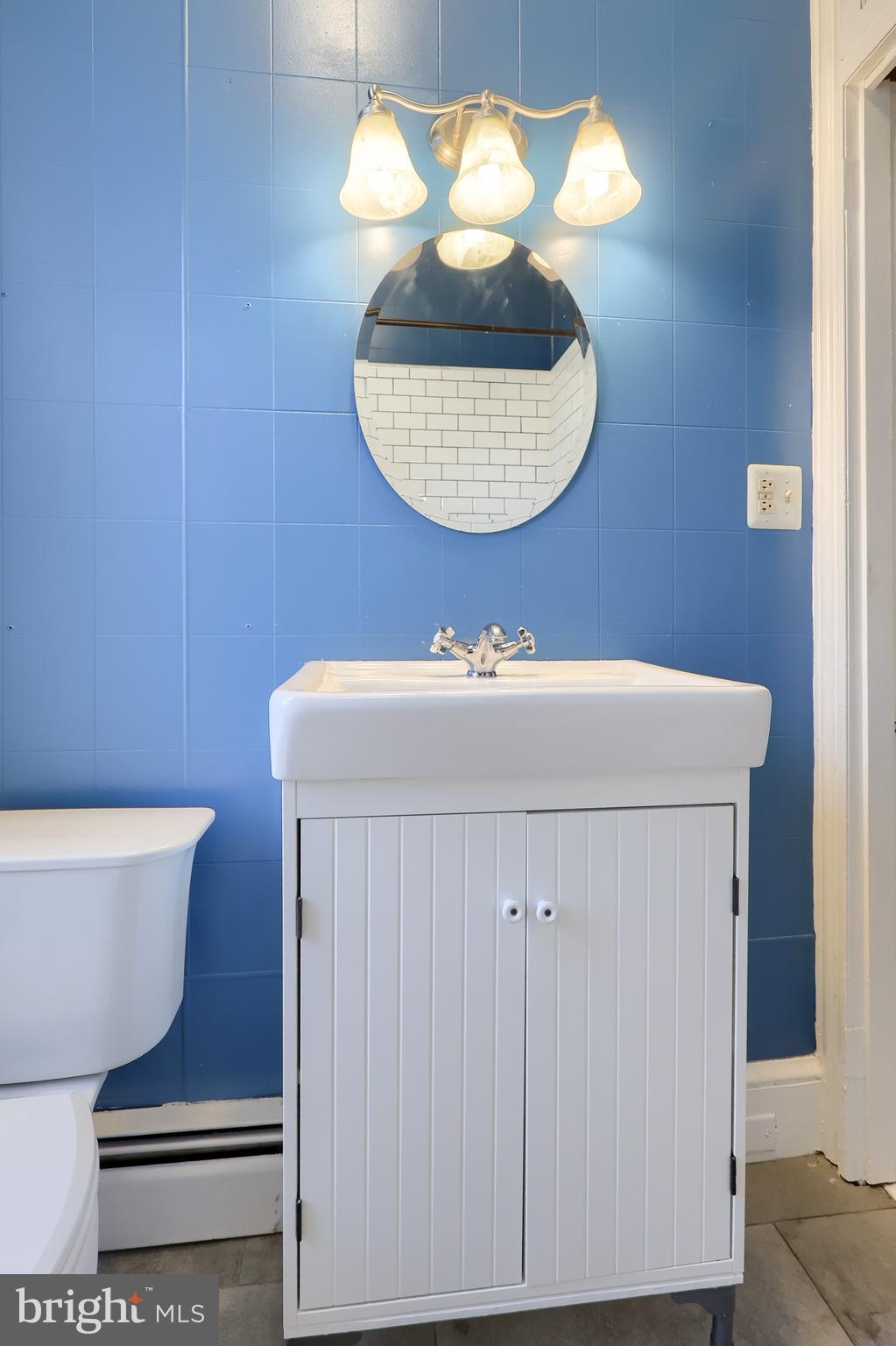 2926 Kutztown Road Reading, PA 19605 - Photo 26 of 49 a bathroom with a sink a mirror and a toilet