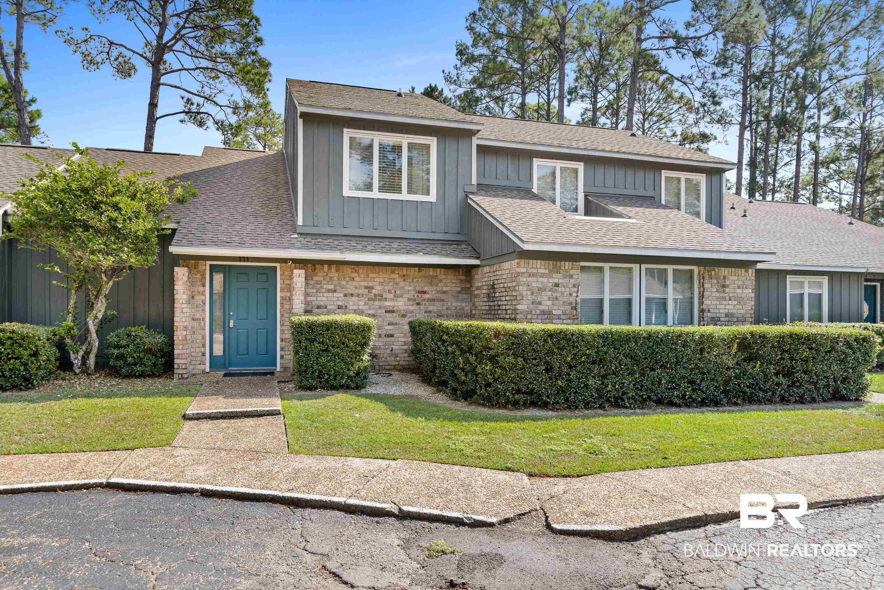 1701 Regency Road, Unit 111 Gulf Shores, AL 36542 - Photo 1 of 29 View of front of house with a front lawn