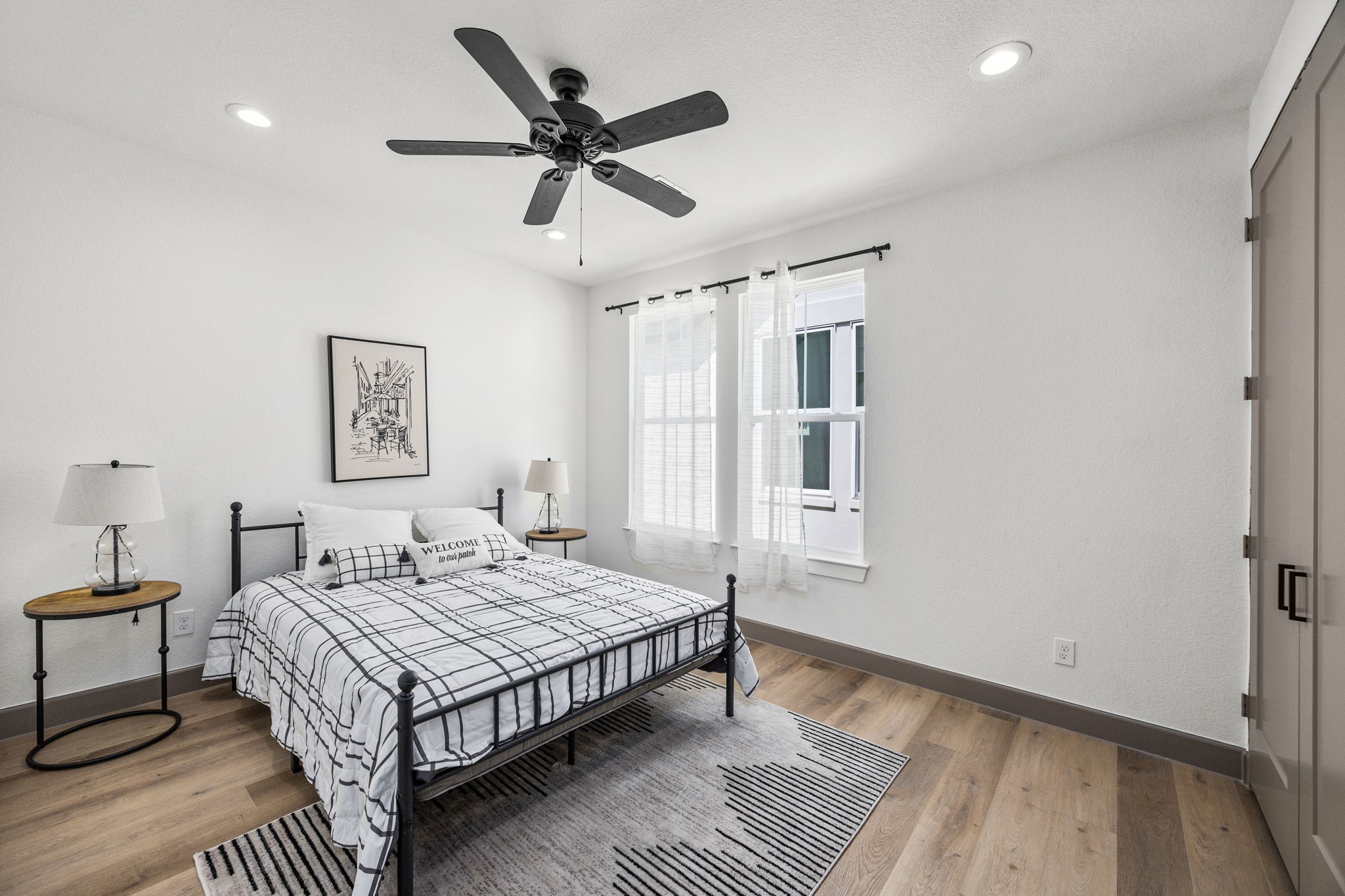 7934 Hennessy Lane, Unit 3 Spring, TX 77389 - Photo 31 of 36 a bedroom with a bed a dresser and a window