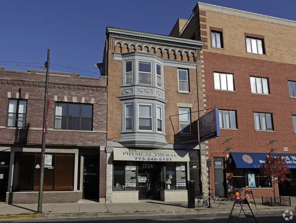 a front view of a brick building with many windows