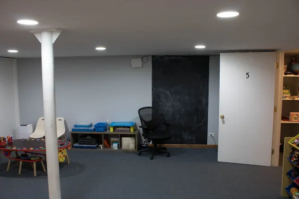 a living room with furniture and a chair