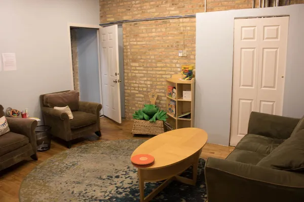 a living room with furniture and a rug