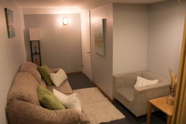 a bedroom with a bed and a couch