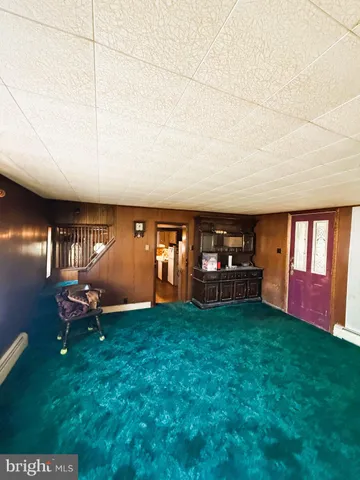 a living room with furniture a air conditioner vent and a counter top