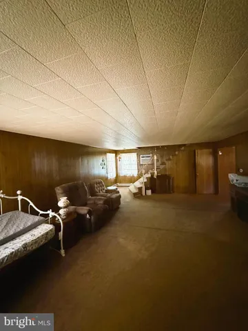 a bedroom with furniture and large windows