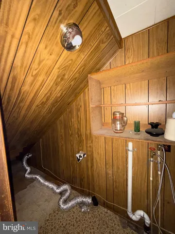 a white toilet sitting next to a shower curtain