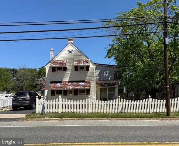 a front view of a house with a garden and plants