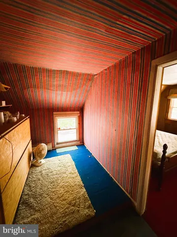 a bedroom with a bed and a mirror