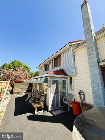 a view of a patio with couches and potted plants