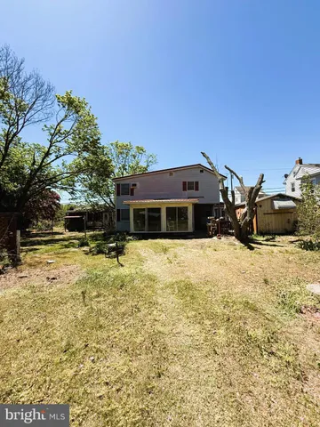 a view of a field with an trees in the background