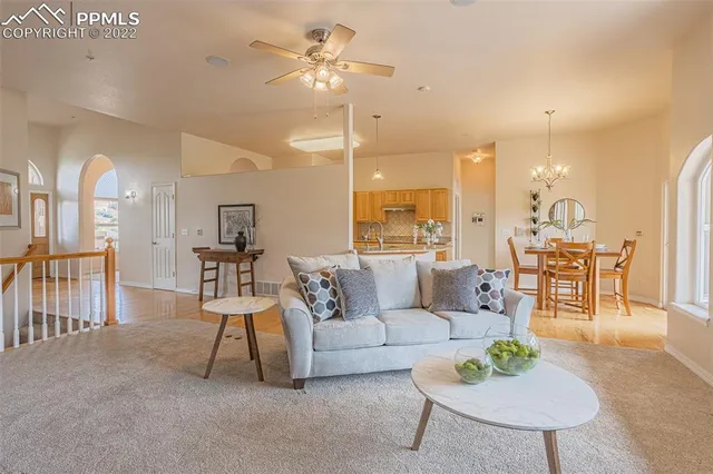 a spacious bedroom with a large bed and a chandelier