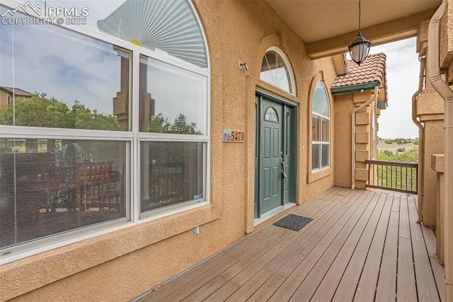 a dining room with furniture a chandelier and wooden floor