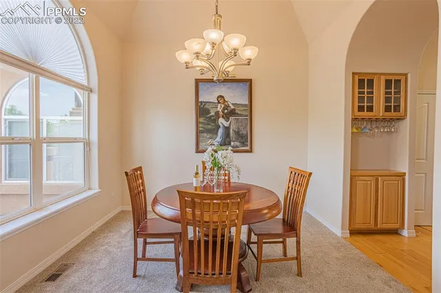 a living room with furniture and a view of kitchen
