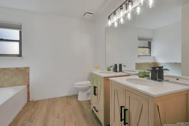 a view of a bathroom with a sink and a mirror