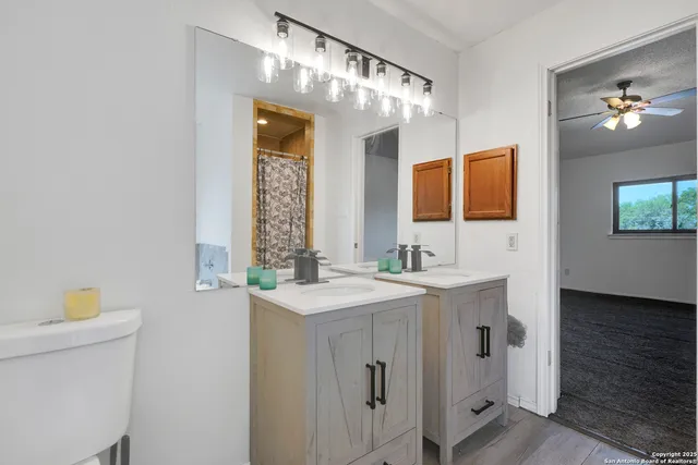 a bathroom with a sink a vanity and a mirror