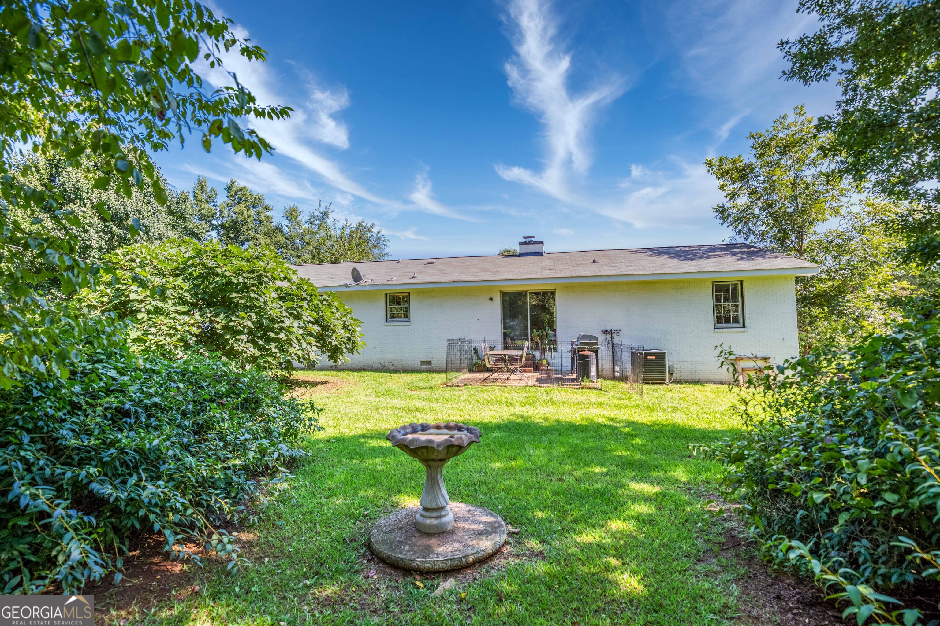 2141 Greensboro Road Madison, GA 30650 - Photo 11 of 35 a front view of a house with swimming pool having outdoor seating