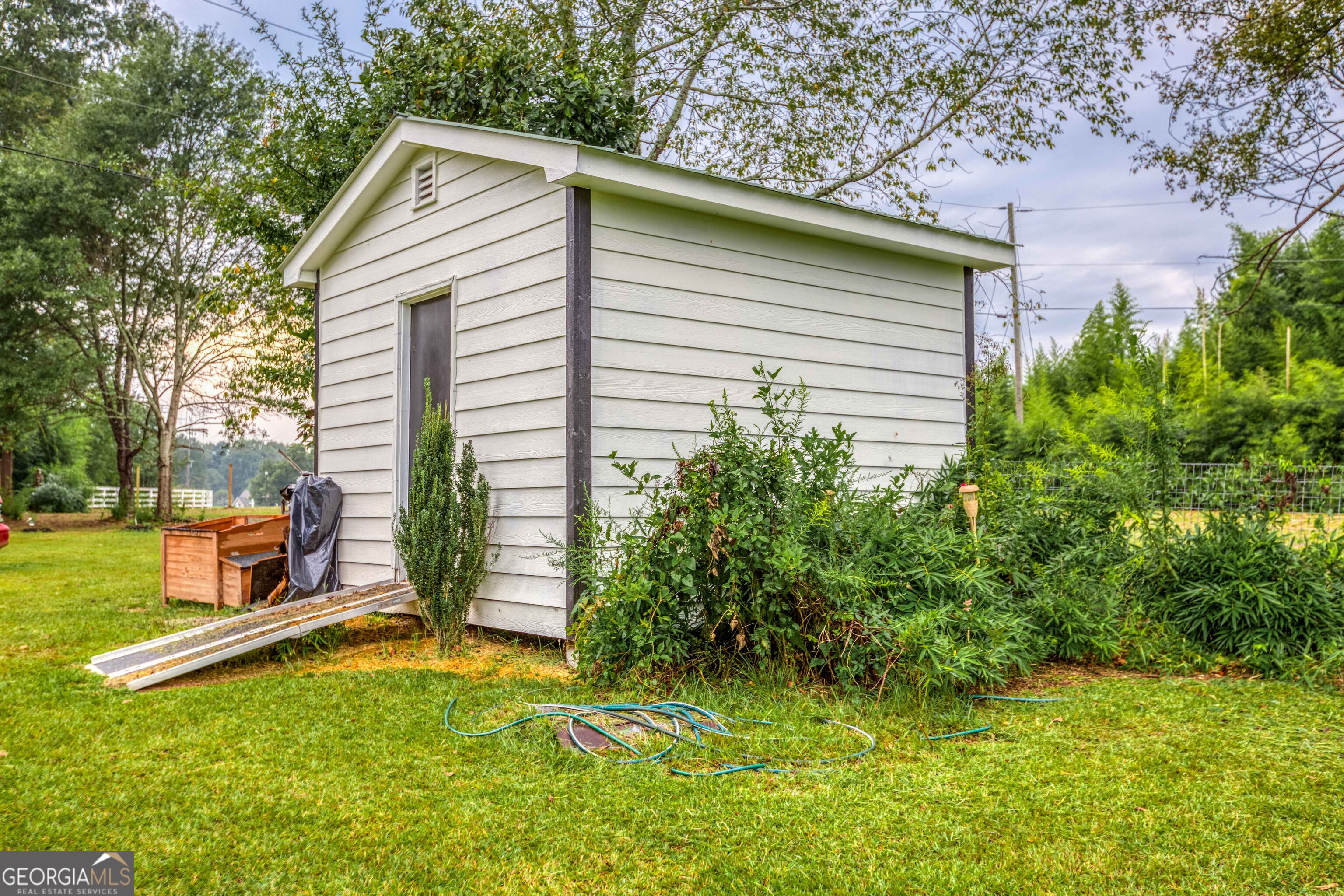 2141 Greensboro Road Madison, GA 30650 - Photo 13 of 35 a view of backyard with a garden and deck