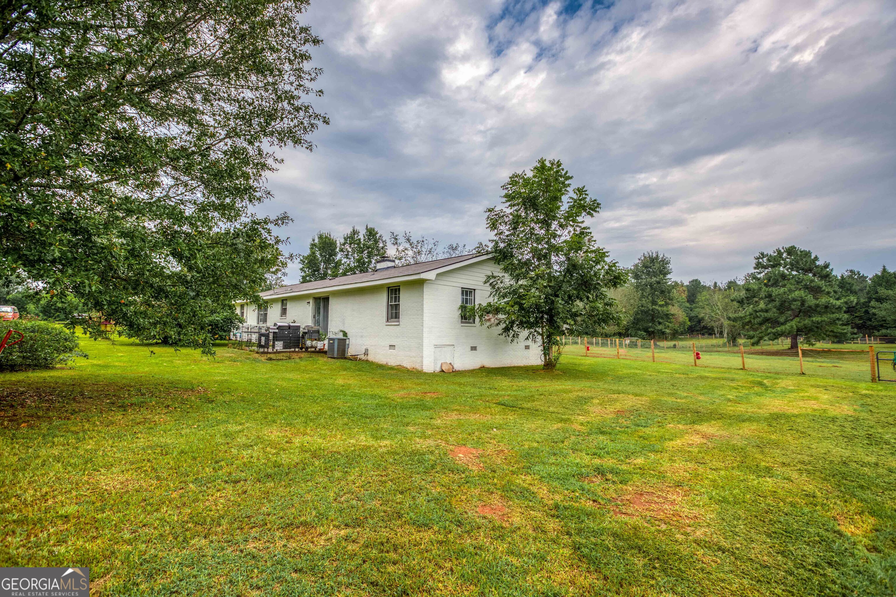 2141 Greensboro Road Madison, GA 30650 - Photo 14 of 35 a view of a big yard with a house