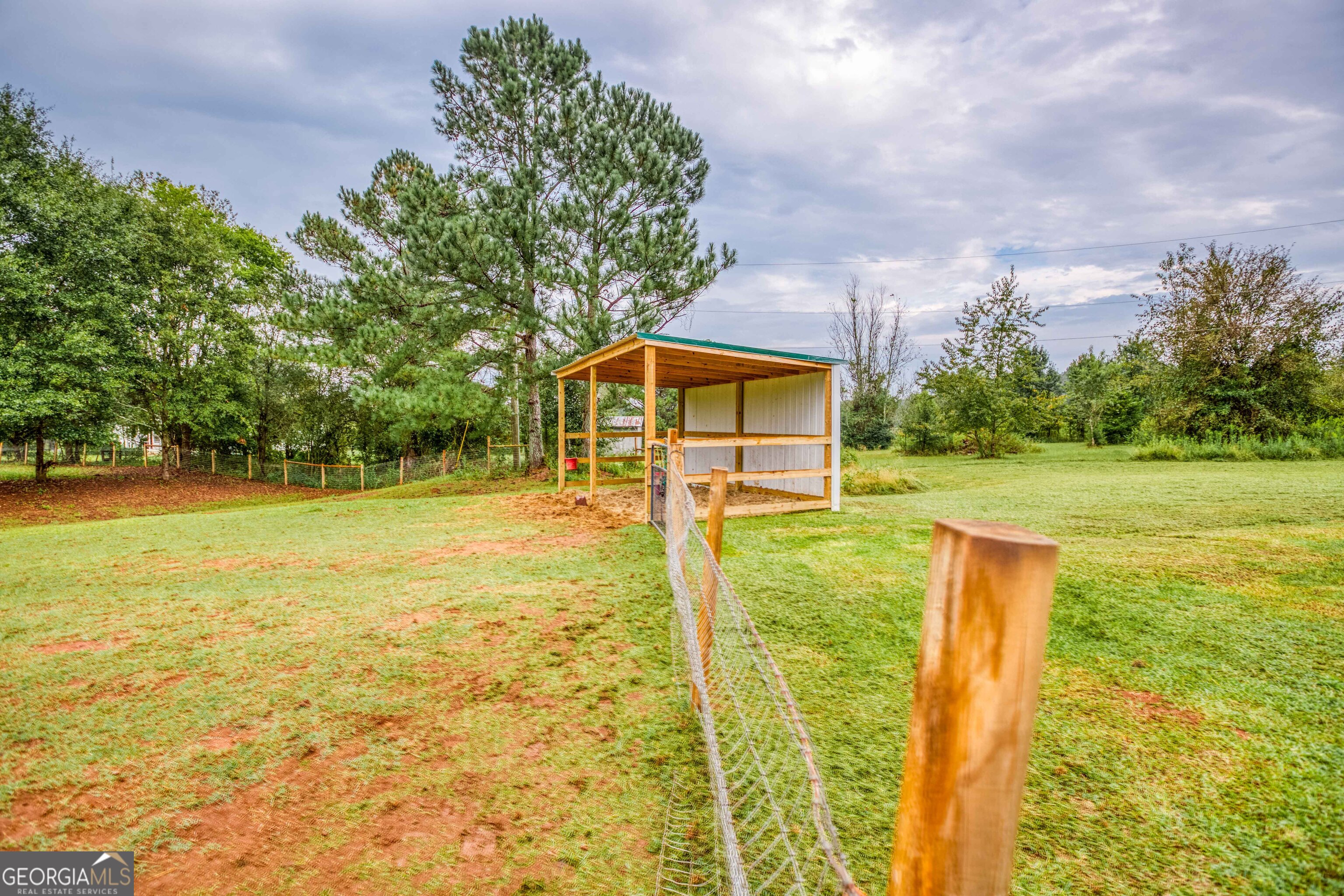 2141 Greensboro Road Madison, GA 30650 - Photo 20 of 35 a backyard of a house with lots of green space and outdoor seating
